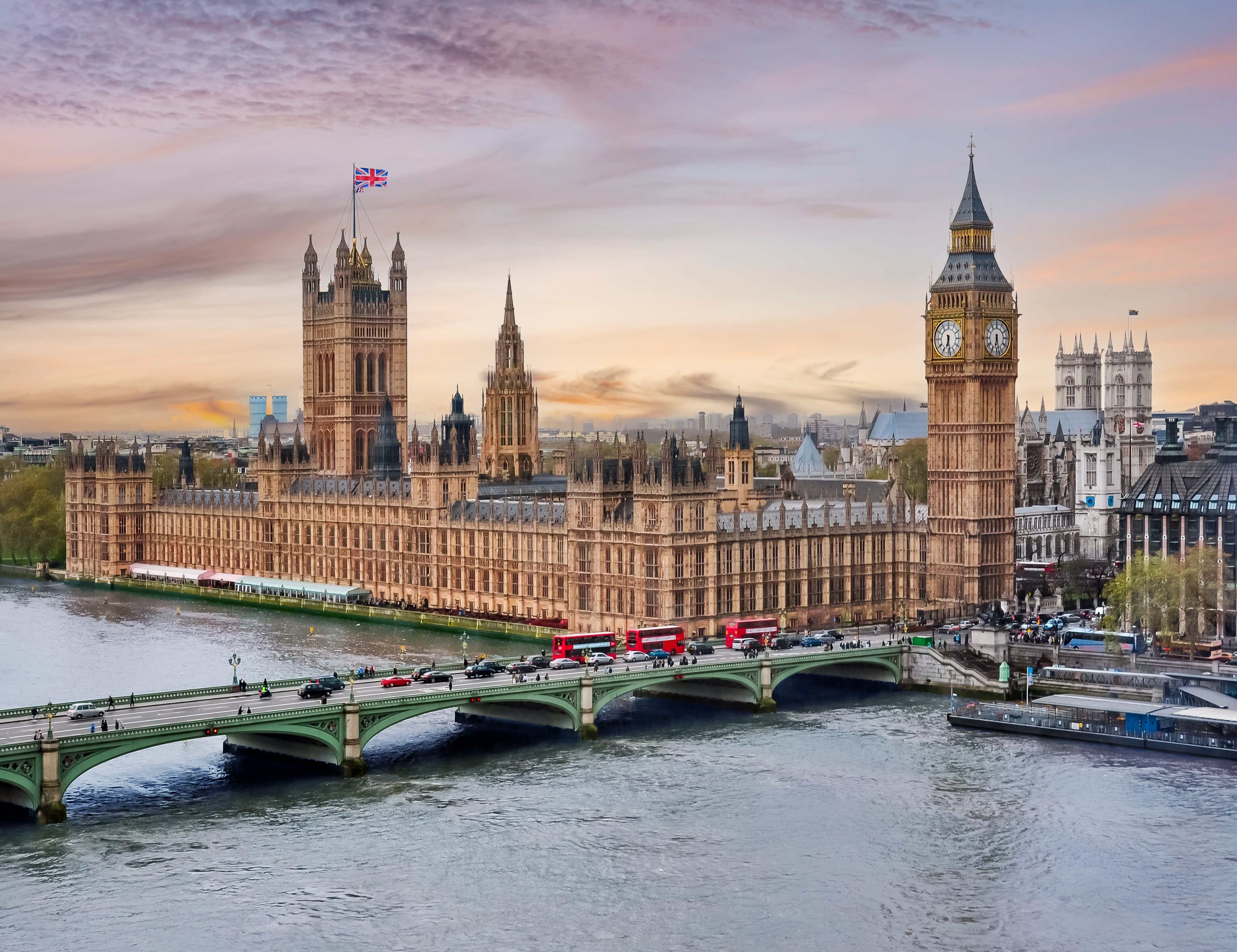 London cityscape with Houses of Parliament and Big Ben tower at sunset, UK